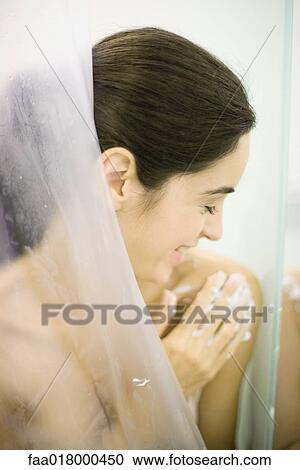 Woman in shower, washing shoulder View Large Photo Image Stock Image - Woman in shower, washing shoulder. Fotosearch
