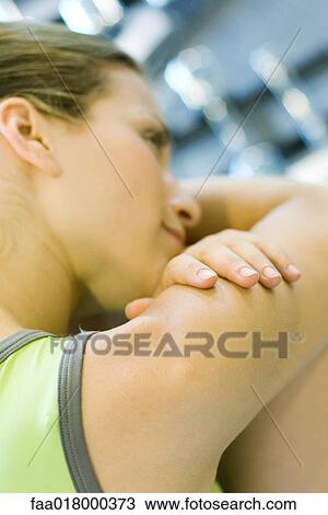 Woman in sports clothes resting head on knees, close-up View Large Photo Image Stock Image - Woman in sports clothes resting head on knees, close-up. Fotosearch