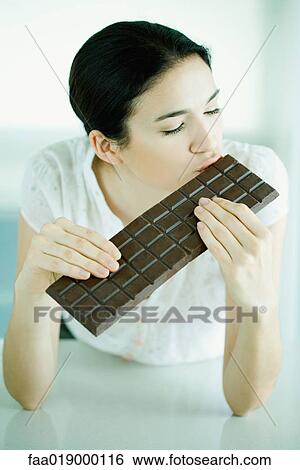Woman kissing large bar of chocolate View Large Photo Image Stock Photograph - Woman kissing large bar of chocolate. Fotosearch