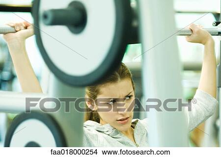 Woman lifting weights View Large Photo Image Picture - Woman lifting weights. Fotosearch