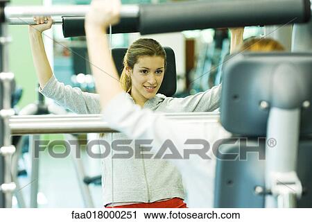 Stock Image - Woman lifting weights. Fotosearch