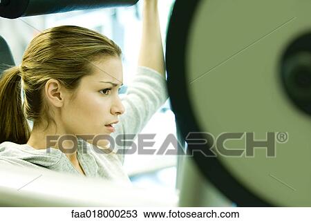 Stock Image - Woman lifting weights. Fotosearch