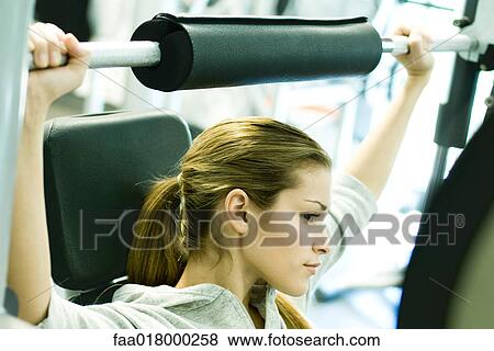 Stock Photo - Woman lifting weights. Fotosearch