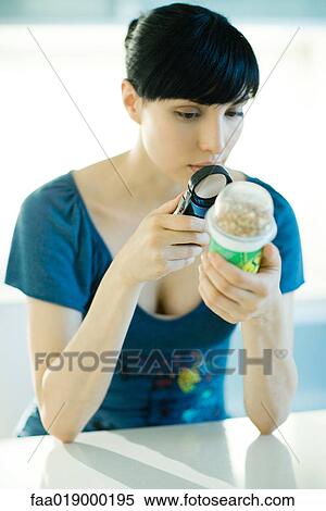 Woman looking at yogurt through magnifying glass View Large Photo Image Stock Photography - Woman looking at yogurt through magnifying glass. Fotosearch