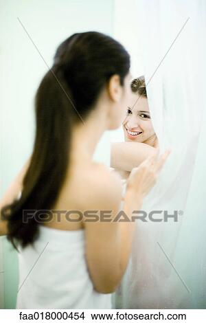 Woman peeking at friend behind shower curtain View Large Photo Image Picture - Woman peeking at friend behind shower curtain. Fotosearch