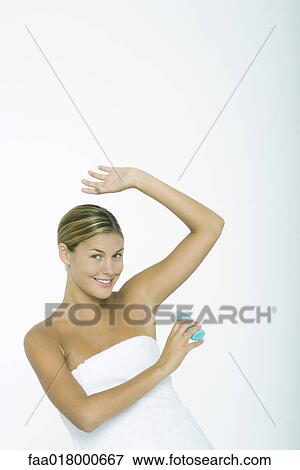 Woman putting on deodorant View Large Photo Image Stock Photo - Woman putting on deodorant. Fotosearch