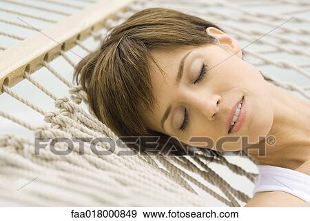 Stock Photo - Woman relaxing on hammock, close-up. Fotosearch