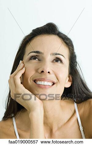 Woman resting head on hand, smiling, looking up, portrait View Large Photo Image Stock Photo - Woman resting head on hand, smiling, looking up, portrait. Fotosearch