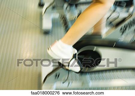 Woman riding exercise bike View Large Photo Image Stock Photograph - Woman riding exercise bike. Fotosearch
