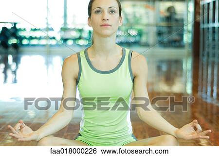Woman sitting in lotus position View Large Photo Image Stock Photograph - Woman sitting in lotus position. Fotosearch