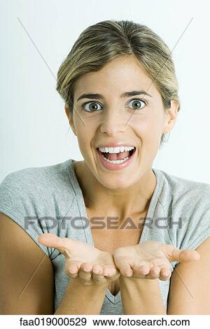 Woman, smiling at camera, holding out palms, portrait View Large Photo Image Stock Photo - Woman, smiling at camera, holding out palms, portrait. Fotosearch