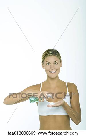 Woman squeezing beauty product into palm of hand View Large Photo Image Stock Photo - Woman squeezing beauty product into palm of hand. Fotosearch