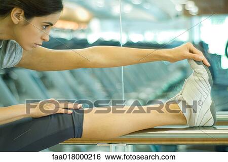 Woman stretching leg on barre View Large Photo Image Stock Photograph - Woman stretching leg on barre. Fotosearch