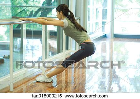 Stock Photography - Woman stretching on barre. Fotosearch