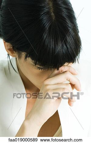 Woman touching bridge of nose, head down View Large Photo Image Stock Photo - Woman touching bridge of nose, head down. Fotosearch