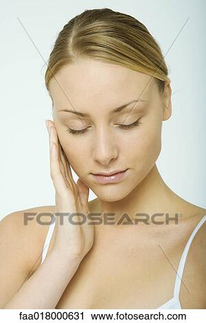 Woman touching cheek, eyes closed, portrait View Large Photo Image Stock Image - Woman touching cheek, eyes closed, portrait. Fotosearch