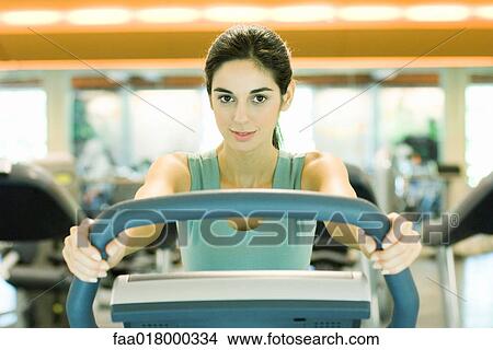 Woman using exercise machine View Large Photo Image Picture - Woman using exercise machine. Fotosearch