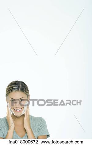 Woman washing face, smiling at camera View Large Photo Image Stock Image - Woman washing face, smiling at camera. Fotosearch