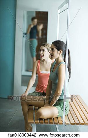 Woman watching friend weigh herself in locker room View Large Photo Image Stock Image - Woman watching friend weigh herself in locker room. Fotosearch