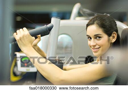 Woman working out with weight machine View Large Photo Image Stock Image - Woman working out with weight machine. Fotosearch