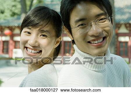 Young couple, back to back, close-up, portrait View Large Photo Image Stock Photo - Young couple, back to back, close-up, portrait. Fotosearch