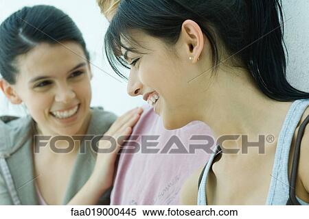 Stock Photography - Young friends laughing, close-up. Fotosearch