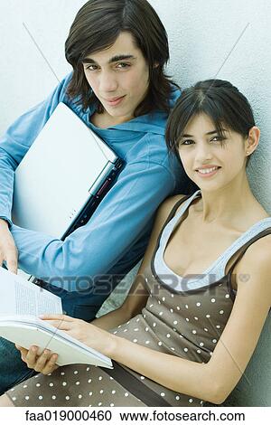 Young friends reading book together View Large Photo Image Stock Image - Young friends reading book together. Fotosearch