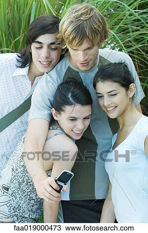 Young friends taking group photo with cell phone View Large Photo Image Stock Image - Young friends taking group photo with cell phone. Fotosearch