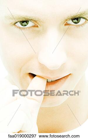 Young man biting thumb View Large Photo Image Stock Photo - Young man biting thumb. Fotosearch