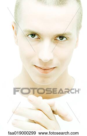 Young man clasping hands, looking at camera View Large Photo Image Stock Photo - Young man clasping hands, looking at camera. Fotosearch