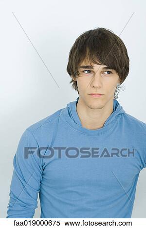 Young man, glancing to the side, portrait View Large Photo Image Stock Photography - Young man, glancing to the side, portrait. Fotosearch