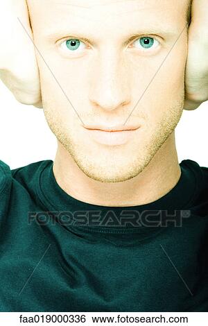 Young man holding hands over ears View Large Photo Image Stock Photograph - Young man holding hands over ears. Fotosearch
