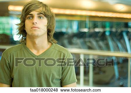 Young man in exercise room, portrait View Large Photo Image Stock Photo - Young man in exercise room, portrait. Fotosearch