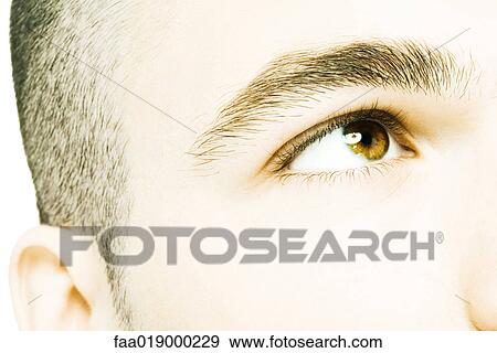 Young man looking up, extreme close-up of face View Large Photo Image Stock Photo - Young man looking up, extreme close-up of face. Fotosearch