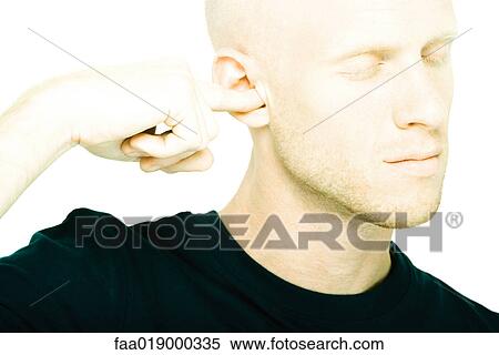 Young man plugging ear with finger, eyes closed View Large Photo Image Stock Photography - Young man plugging ear with finger, eyes closed. Fotosearch