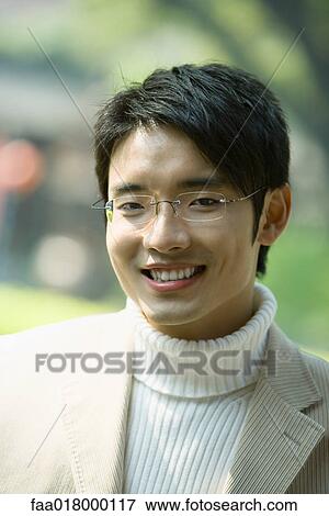 Young man smiling at camera, portrait View Large Photo Image Stock Photo - Young man smiling at camera, portrait. Fotosearch