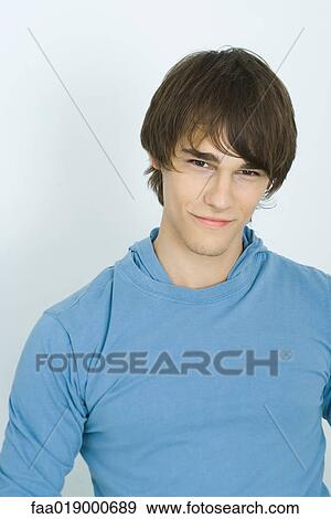Young man, smiling at camera, portrait View Large Photo Image Stock Photo - Young man, smiling at camera, portrait. Fotosearch