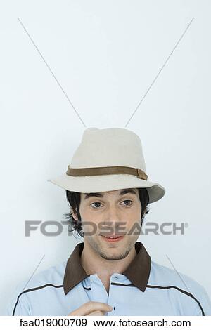Young man wearing hat, looking away View Large Photo Image Stock Photo - Young man wearing hat, looking away. Fotosearch