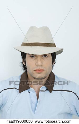 Young man wearing hat, portrait View Large Photo Image Stock Image - Young man wearing hat, portrait. Fotosearch