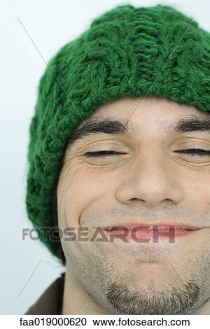 Young man wearing knit hat, eyes closed, portrait, close-up View Large Photo Image Stock Image - Young man wearing knit hat, eyes closed, portrait, close-up. Fotosearch