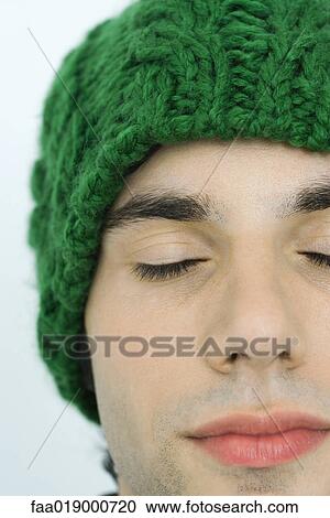 Young man wearing knit hat, eyes closed, portrait, close-up View Large Photo Image Stock Image - Young man wearing knit hat, eyes closed, portrait, close-up. Fotosearch