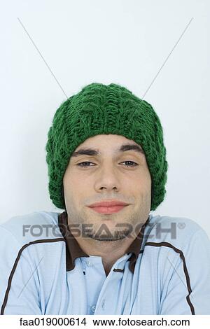Young man wearing knit hat, portrait, close-up View Large Photo Image Picture - Young man wearing knit hat, portrait, close-up. Fotosearch