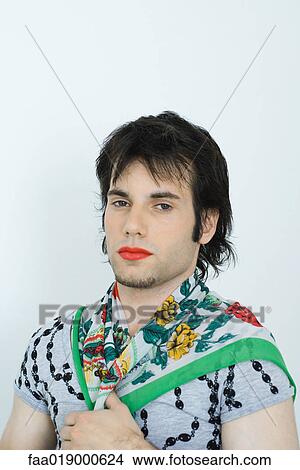 Young man wearing lipstick and scarf around neck, portrait View Large Photo Image Picture - Young man wearing lipstick and scarf around neck, portrait. Fotosearch