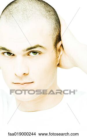 Young man with hand behind head, portrait View Large Photo Image Picture - Young man with hand behind head, portrait. Fotosearch