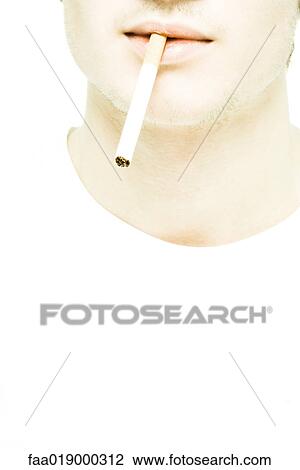 Young man's lower face, cigarette between lips, extreme close-up View Large Photo Image Stock Image - Young man's lower face, cigarette between lips, extreme close-up. Fotosearch