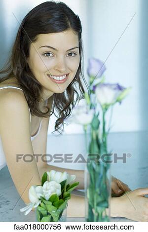 Young woman and fresh flower arrangement, portrait View Large Photo Image Stock Photograph - Young woman and fresh flower arrangement, portrait. Fotosearch