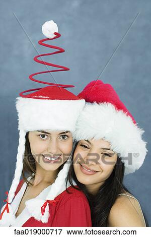 Stock Photo - Young woman and teenage girl wearing holiday costumes, portrait. Fotosearch