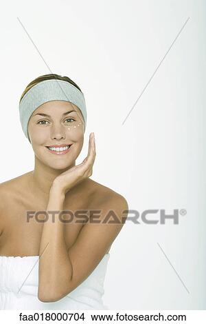 Young woman applying moisturizer under eye View Large Photo Image Picture - Young woman applying moisturizer under eye. Fotosearch