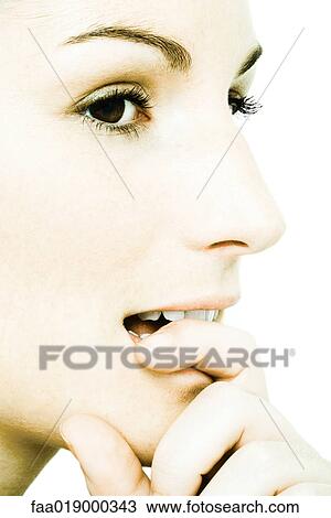 Young woman biting finger, extreme close-up View Large Photo Image Stock Image - Young woman biting finger, extreme close-up. Fotosearch