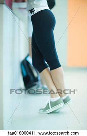 Young woman checking in at health club counter, waist down View Large Photo Image Stock Image - Young woman checking in at health club counter, waist down. Fotosearch